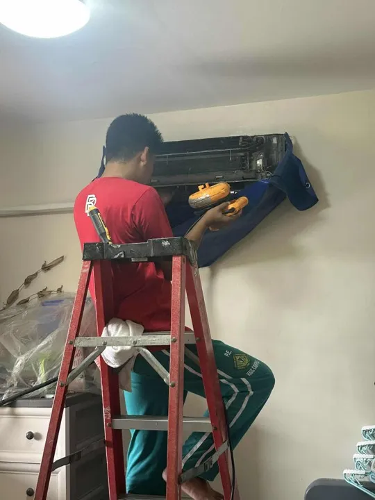 Technicians servicing residential indoor unit